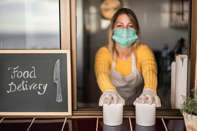 Woman at Pick Up Window Wearing a Mask