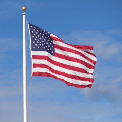 Picture of U.S. Flag against a blue oklahoma sky
